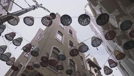 colorful baskets hanging in a city alley