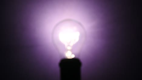 focus of light bulb at violet background