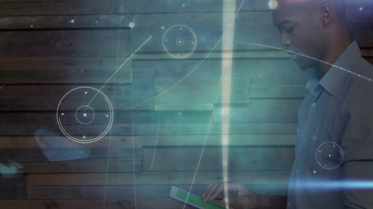 Man tapping tablet in technology office, with glowing holographic charts floating around