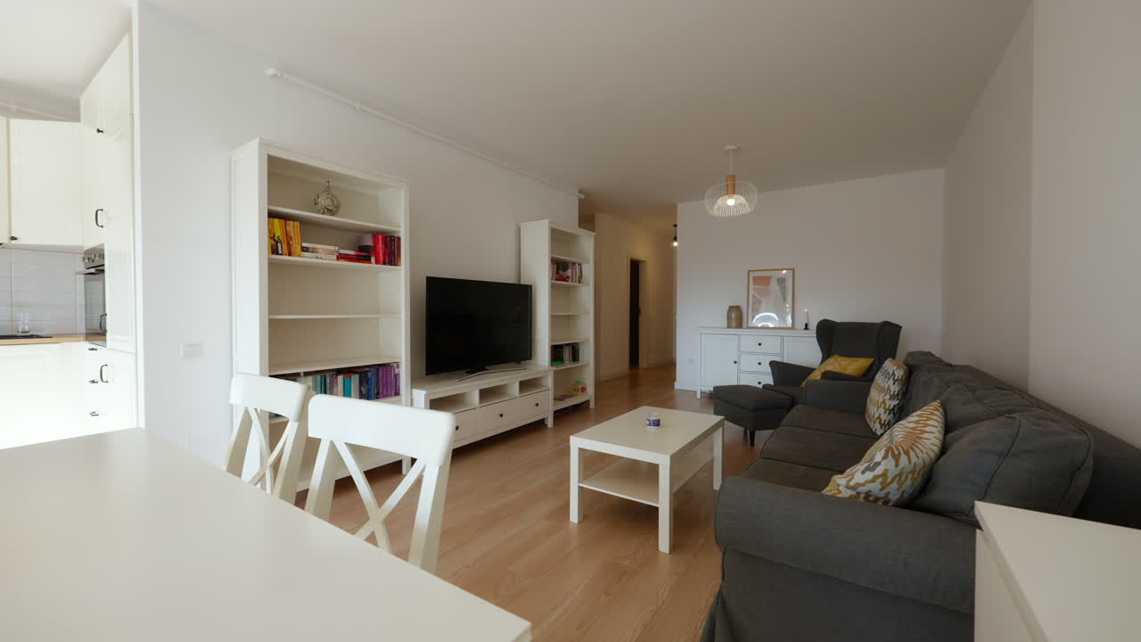 Modern, bright furnished living room of a new apartment with kitchenette