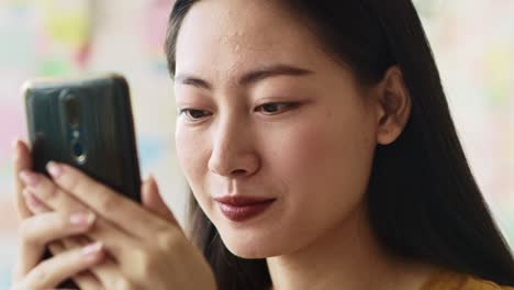 Handheld-view-of-focused-young-woman-looking-at-mobile-phone