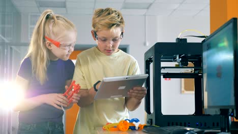 children are managing a scientific experiment with the help of a tablet computer