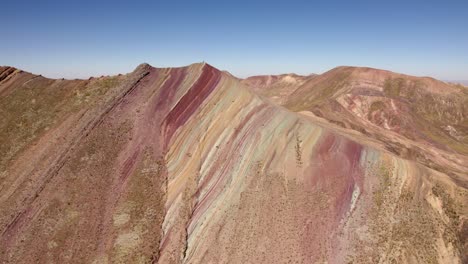 rainbow mountain showcases layers of vibrant colors against a backdrop of the andes.