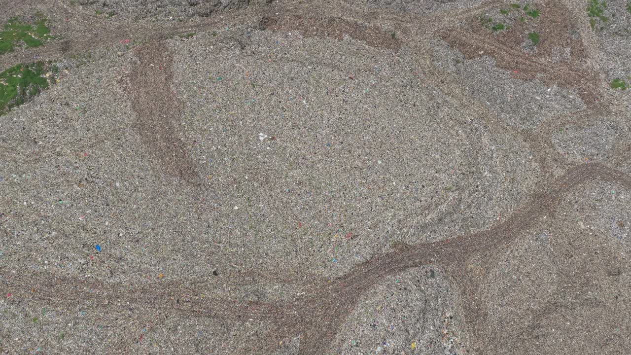 Aerial top down view of a landfill with tire tracks