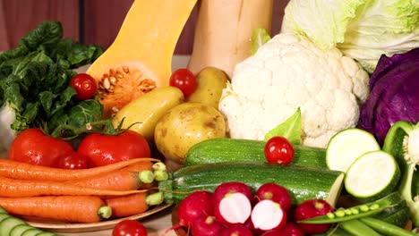 assortment of fresh vegetables displayed on wood