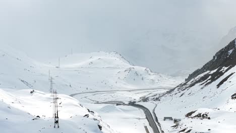 snowy aerial panorama of winding road through mountain pass, malojapass, switzerland