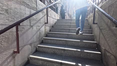 person ascending stairs in urban paris setting