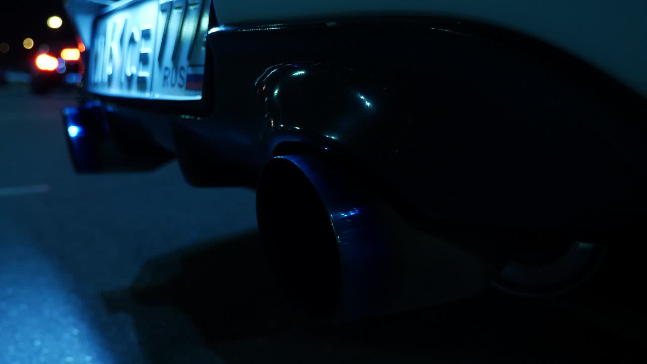 Close-up of a car's exhaust pipe at night