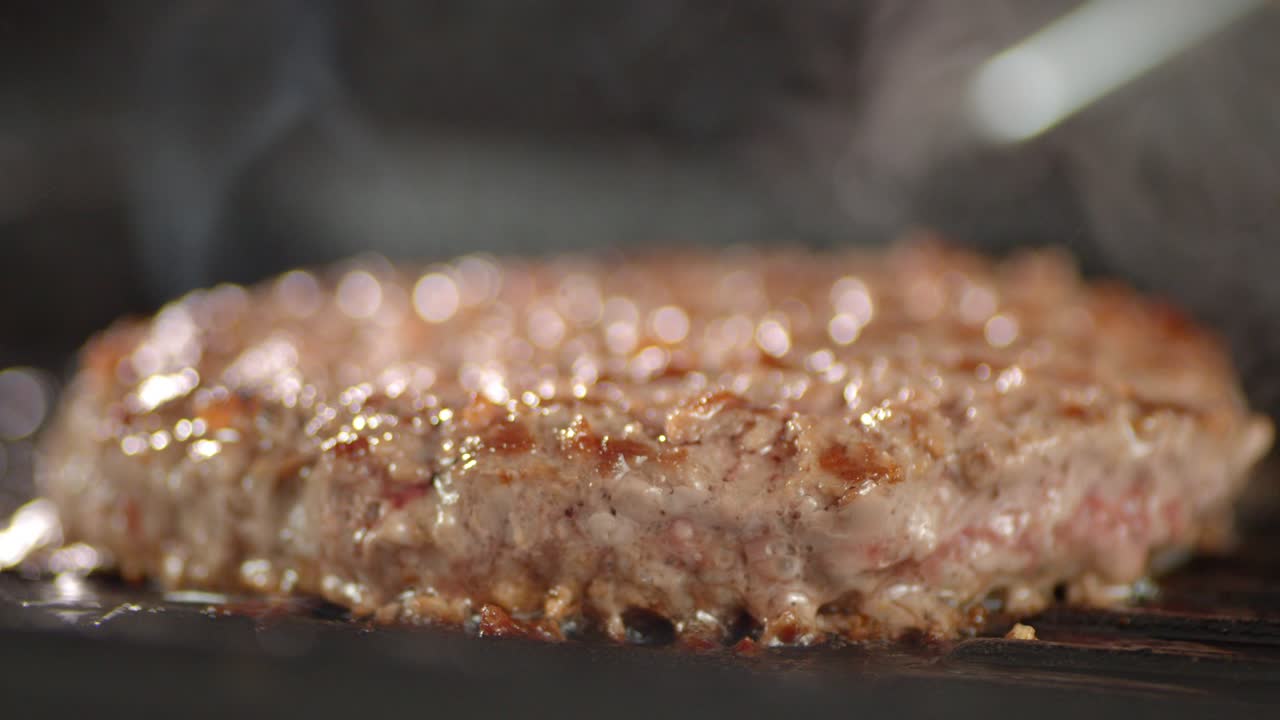 Cooking burger meat in a frying pan.