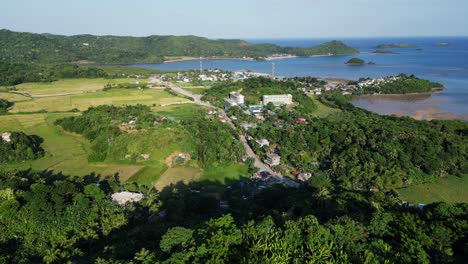 Aerial---Wide-shot-of-beautiful-waterfront-town-with-green-spaces