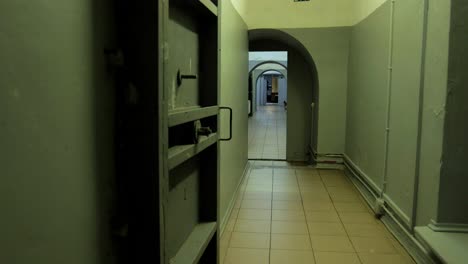 hallway inside the concrete bomb shelter to hide civil people, an underground apocalypse bunker built in old coastal fortification, wide handheld dolly shot moving right