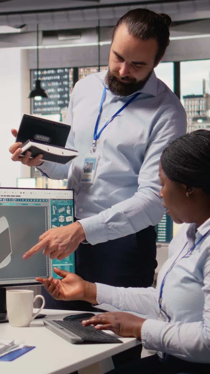 Team leader supervising work done by engineer creating solar cell energy device