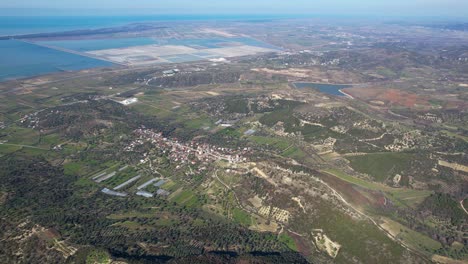 Aerial-view-of-coastline-in-Vlora-Albania-with-lagoon-and-salt-factory-on-shore-of-beautiful-hilly-coast