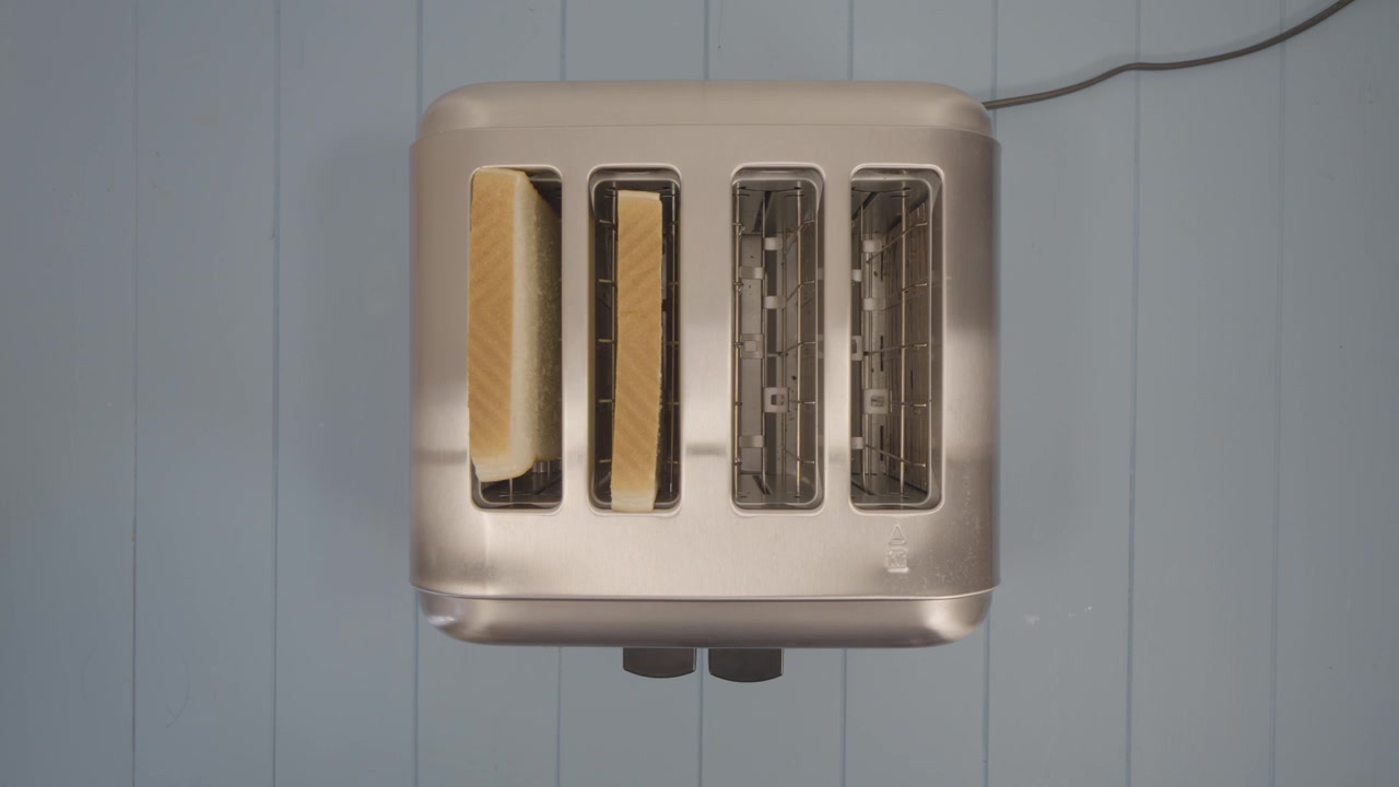 top down view of three Toasted Slices of Sandwich Bread put inside a Chromed Toaster