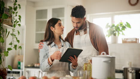 couple learning a recipe together in the kitchen