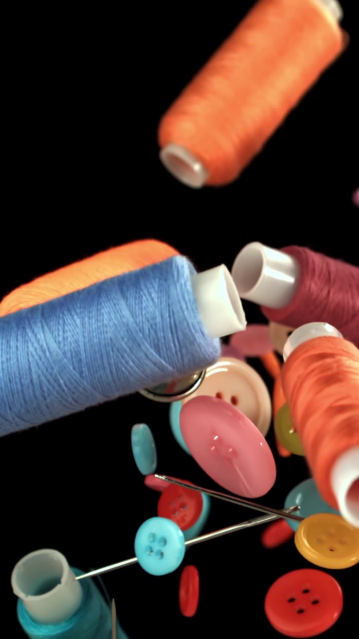 Colorful Sewing Supplies and Buttons Falling in Slow Motion