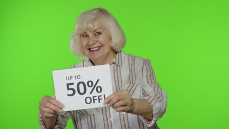 senior grandmother showing up to 50 percent off inscription, advertising discounts, looking amazed