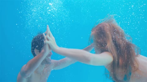 happy couple swimming underwater