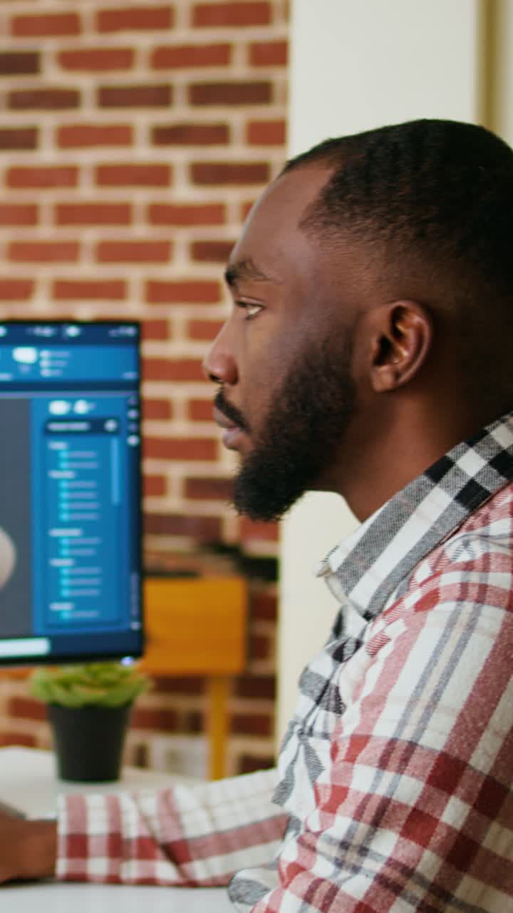 Vertical Video Engineer designs a turbine in an industrial office using CAD software