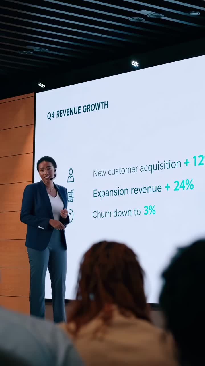 A businesswoman presents growth data on a screen. Low-angle shot, ideal for corporate video
