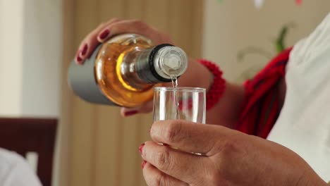 Crop-Mexican-woman-pouring-tequila