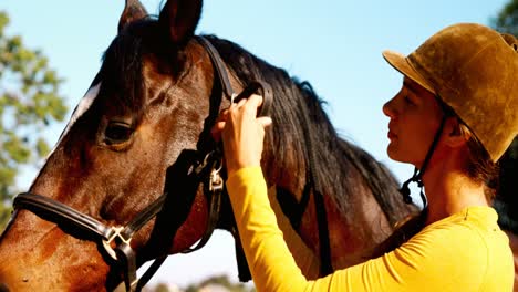 woman standing with the horse in the ranch 4k