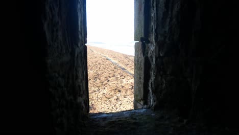 view through ancient stone castle window overlooking moorland highland countryside wilderness dolly right