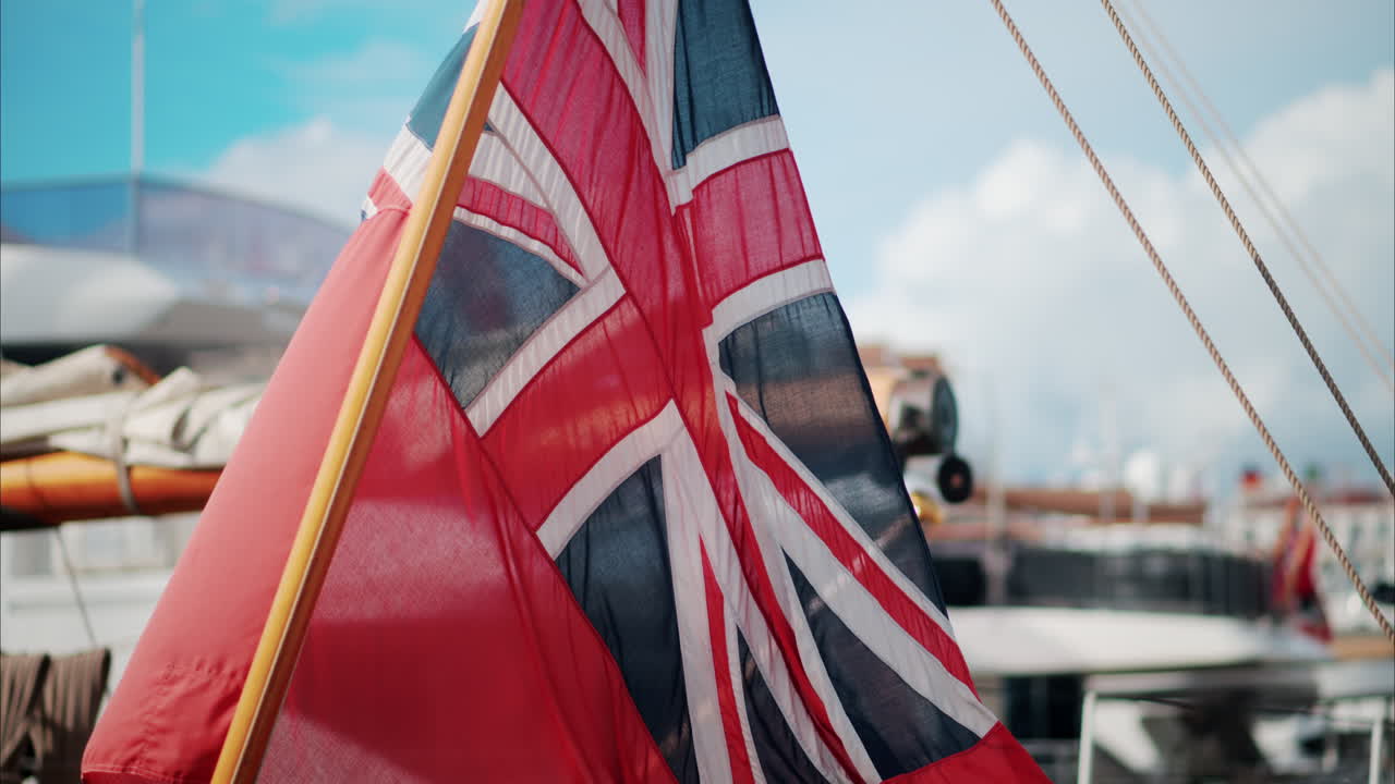The Red Ensign British marine flag on a boat docked in the port of Cannes, France
