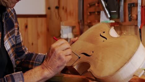 female luthier at work in her workshop