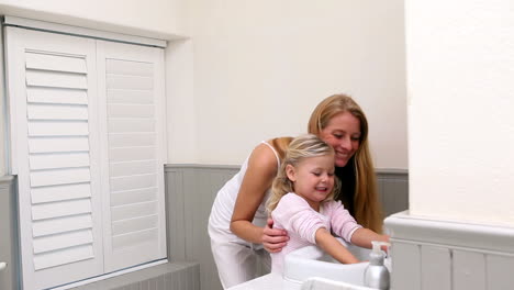 Cute-little-girl-washing-hands-with-her-mother