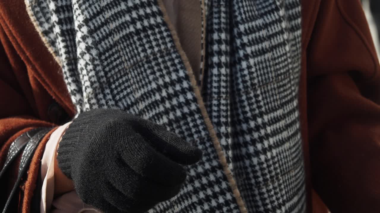 검은 장갑, 플레이드 스카프와 갈색 코트를 입은 여자