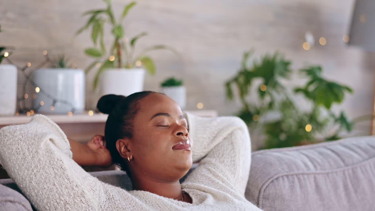 Black woman, relax and living room sofa rest