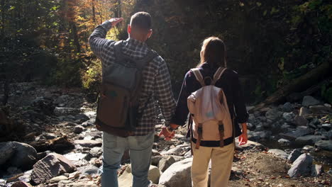 couple hiking in autumn forest