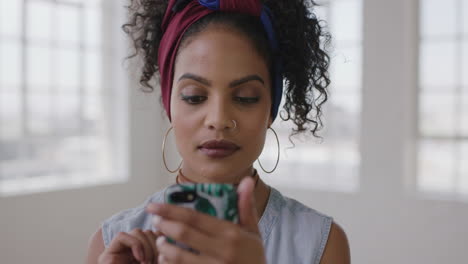 slow-motion-portrait-of-young-hispanic-woman-in-new-apartment-smiling-enjoying-texting-browsing-using-smartphone-social-media-technology