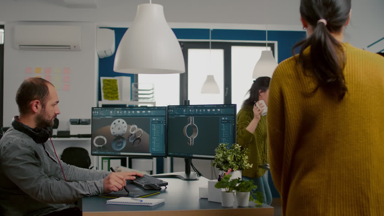 Industrial designer with headset working on PC