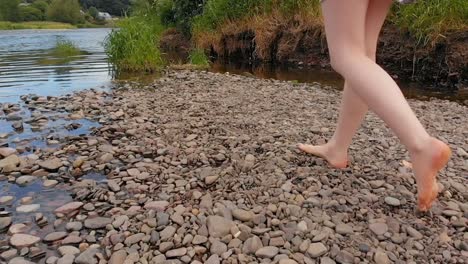 woman walking near riverside 4k