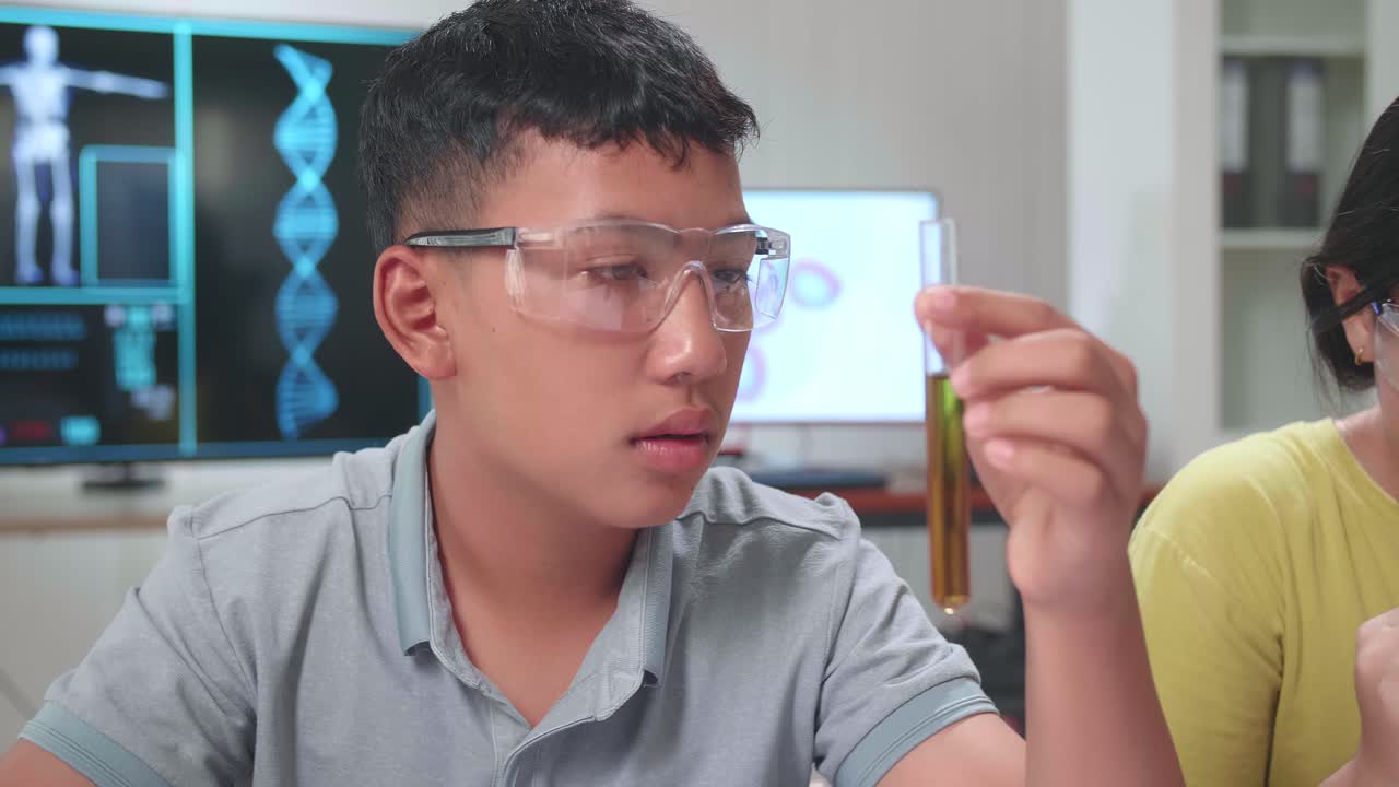 Young Asian Boy And Girl Learning Science Experiment In Laboratory At Classroom. Study With Scientific Equipment And A Microscope