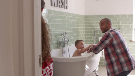 children having bath and brushing teeth in bathroom