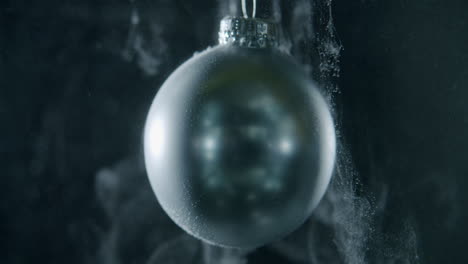 xmas bauble floating on a dark background