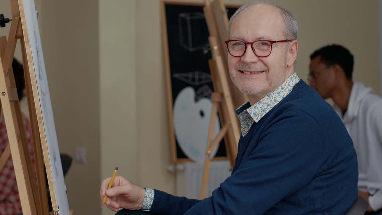 Portrait of senior man attending drawing workshop in studio