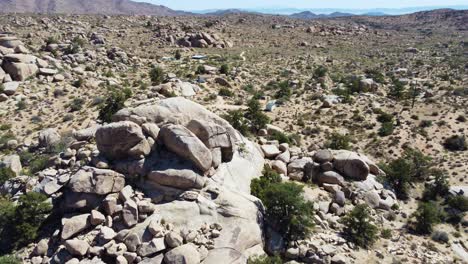 massive stone boulders in deserted terrain in orbit drone view