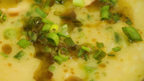 close-up of creamy potato soup with green onions