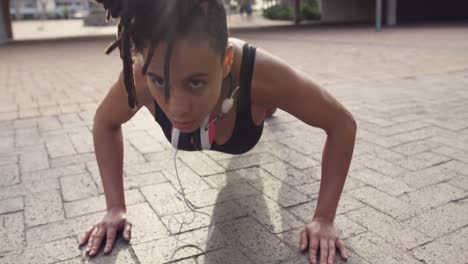 Front-view-of-young-African-American-woman-exercising-in-the-city-4k