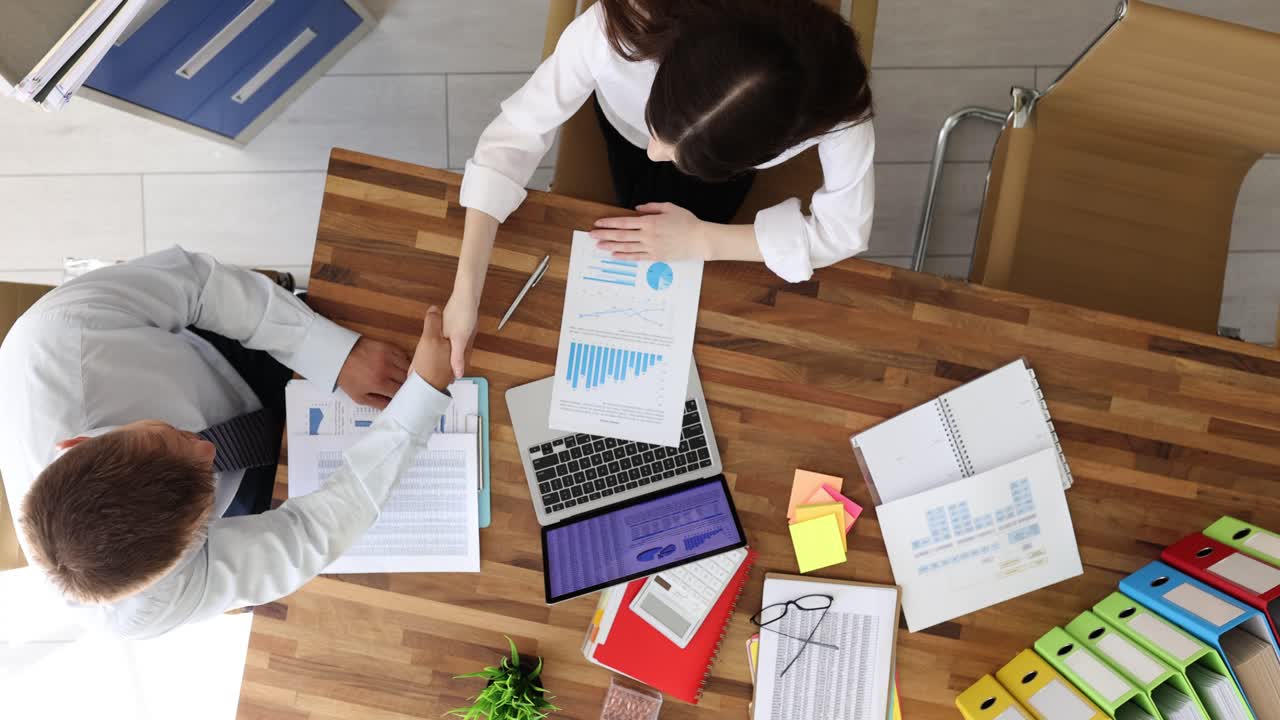 Business Meeting with Handshake and Data Analysis