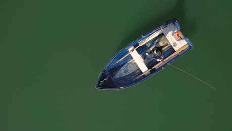 Woman-on-the-boat-catches-a-fish-on-spinning-in-Norway.