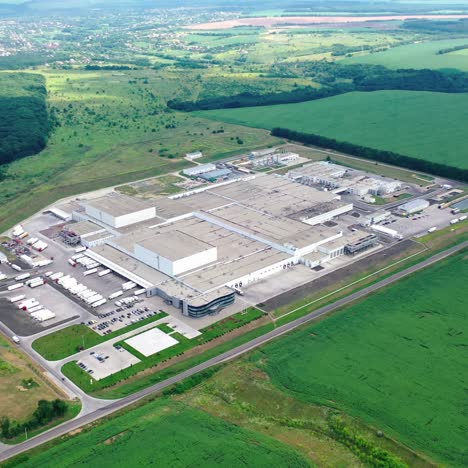 manufacturing on green nature background. modern industrial territory surrounded by beautiful nature environment. view from above