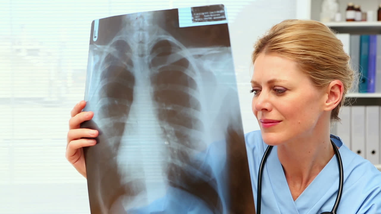 Surgeon examining xray at her desk