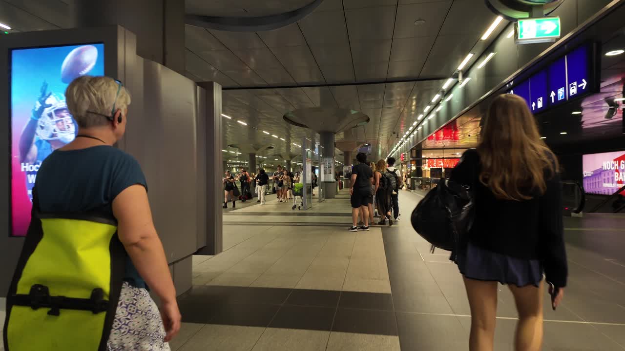 Attendees queue at a busy, well-lit station in Berlin during the IFA event, showcasing the city's energy