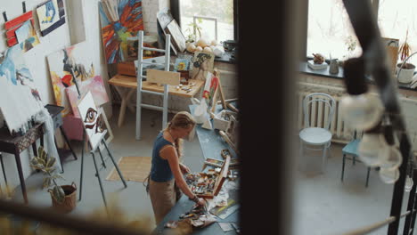 woman artist painting in her studio