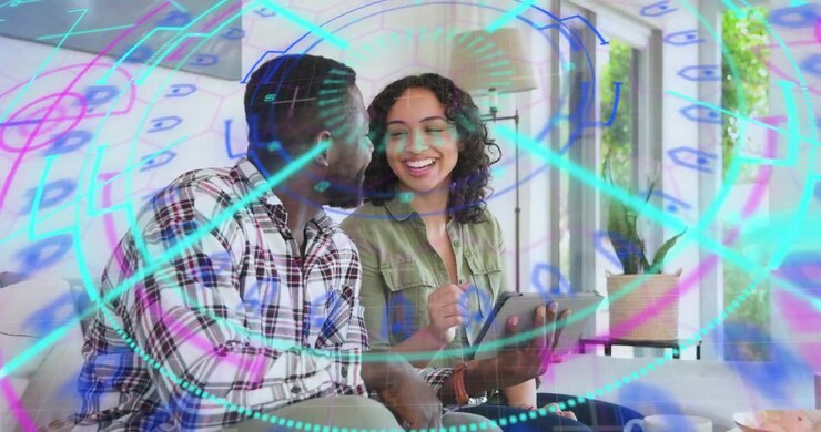 Man using tablet and activating digital shapes swirling then fading around couple for tech demo